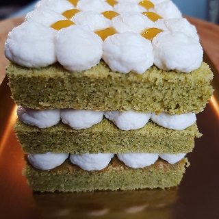 Pistachio cake with whipped cream and apricot puree